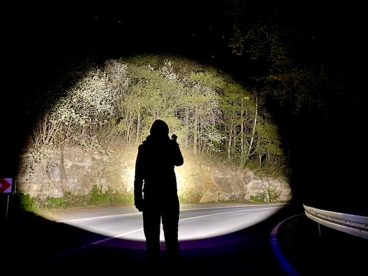 Silhouette einer Frau vor einem Lichtkegel