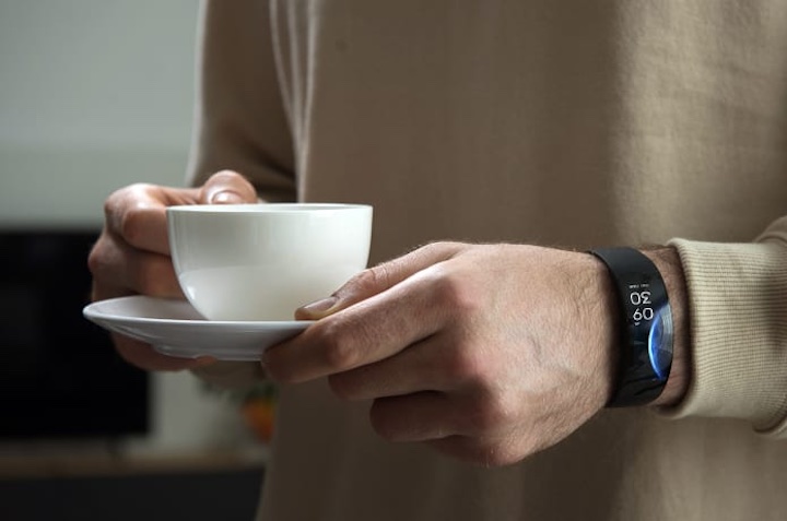 mann mit smartwatch h%C3%A4lt kaffeetasse in der hand