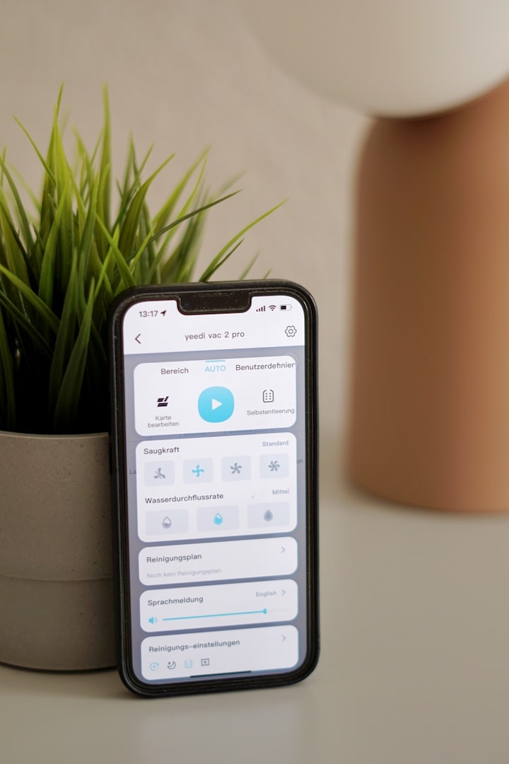 yeedi app auf einem iphone vor einer pflanze
